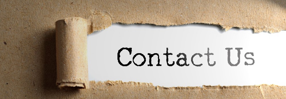 Contact Us typed on paper behind torn cardboard