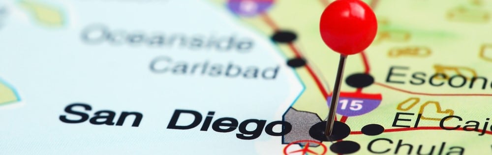 Red map pin on San Diego on a map with Carlsbad, Oceanside and Escondido